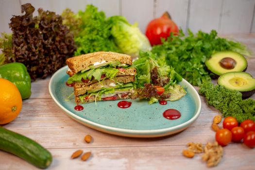 Vibrant vegetable sandwich with fresh produce and salad garnish, perfect for healthy eating.