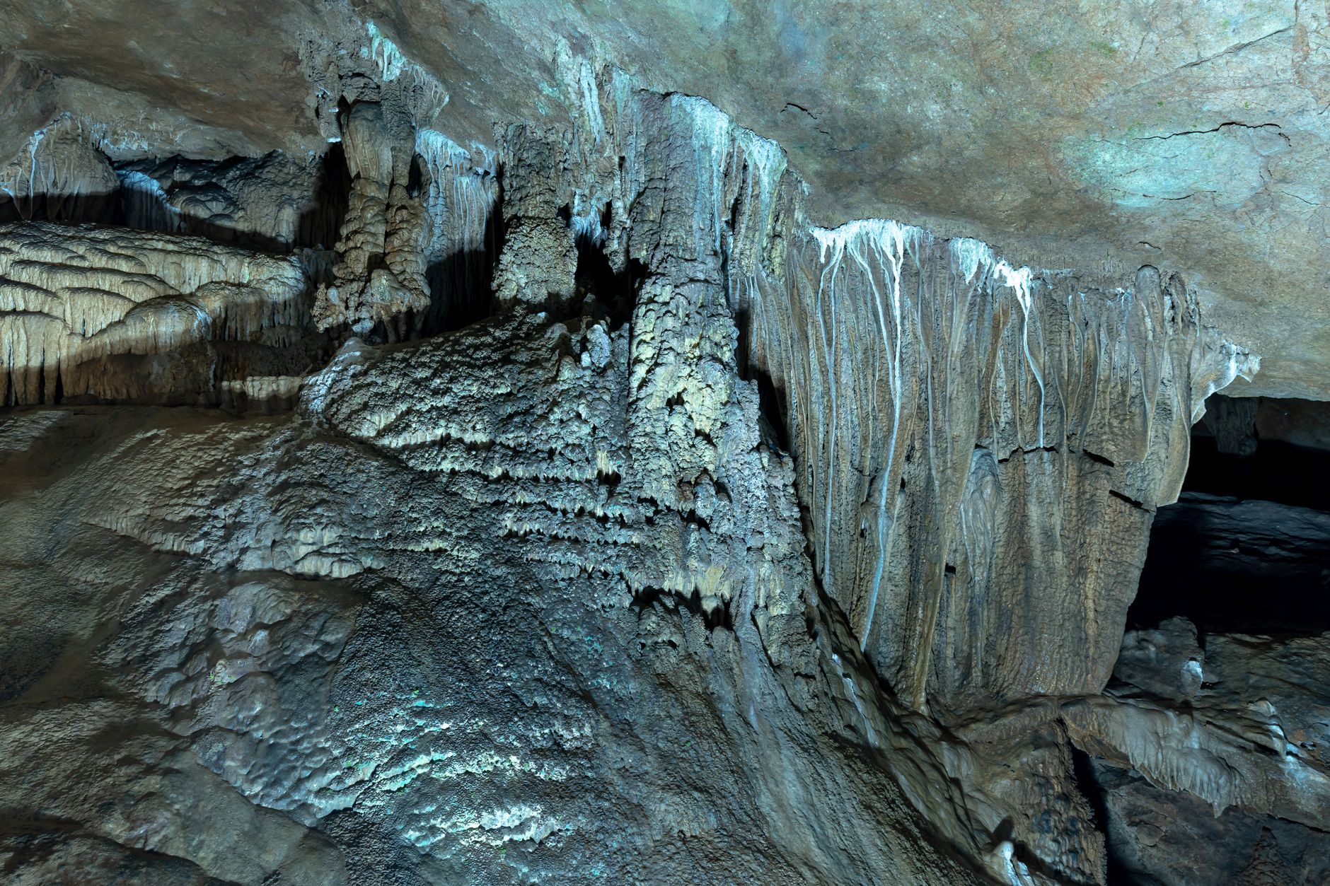 Explore stunning stalactites and stalagmites in a breathtaking cave setting.
