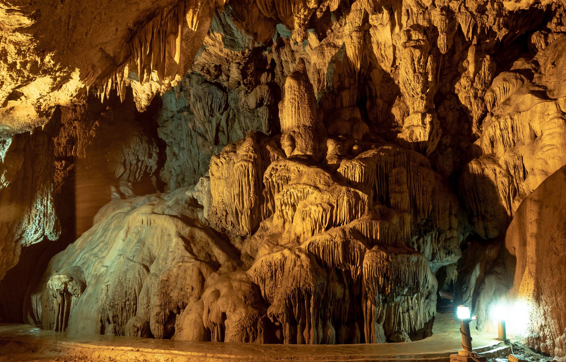 Explore a captivating cave interior with stunning stalactites and stalagmites formations.