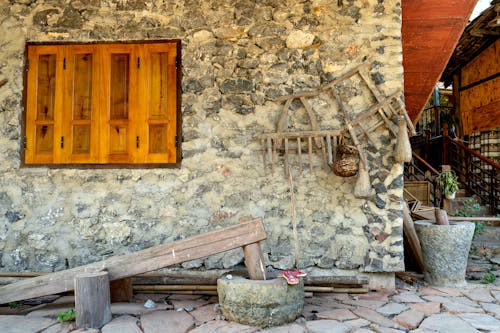 Antique Wooden Items Outside of a House 