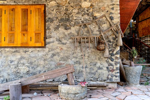 Free Antique Wooden Items Outside of a House  Stock Photo