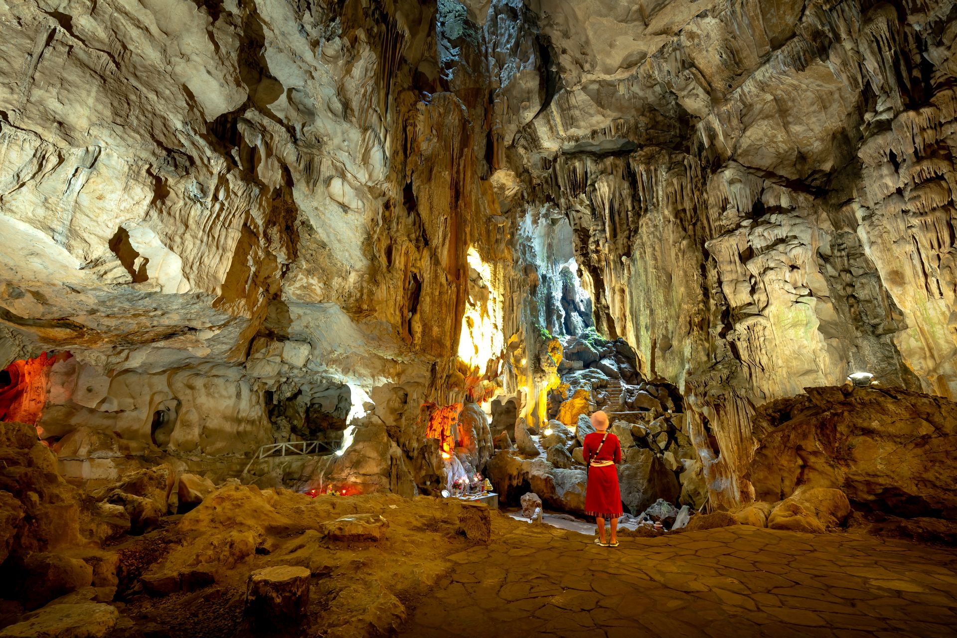 The interior gallery of a limestone cave in dim light.