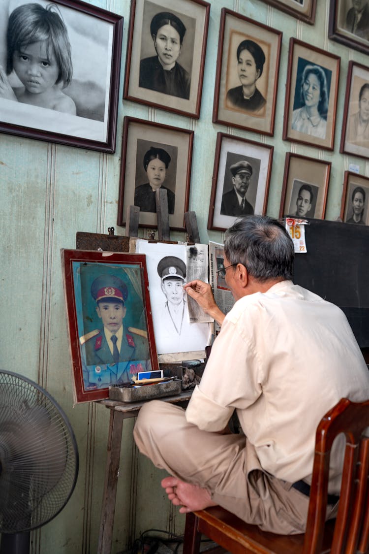 Man Drawing A Portrait From A Photograph 