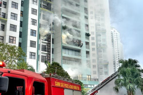 Firefighters Extinguishing a Fire of a Building in City 