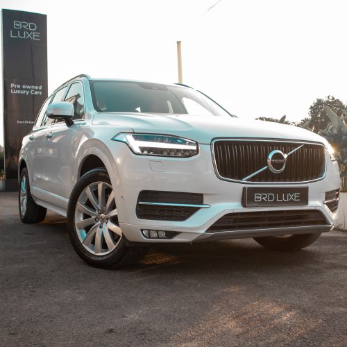 Free A sophisticated white luxury SUV showcased outdoors at a dealership. Stock Photo
