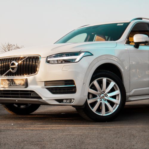 Free Modern white Volvo SUV showcasing luxury design and features on an outdoor road. Stock Photo