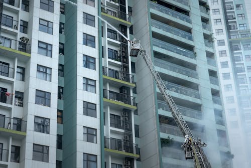 Firefighters Extinguishing a Fire of a Building in City 