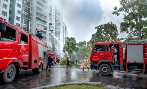 Free Emergency response with firefighters tackling a residential building fire in urban setting. Stock Photo