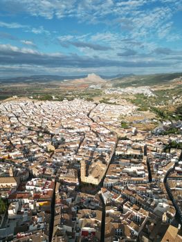 Stunning aerial view of Antequera, Spain showcasing historic buildings and landmark landscape.
