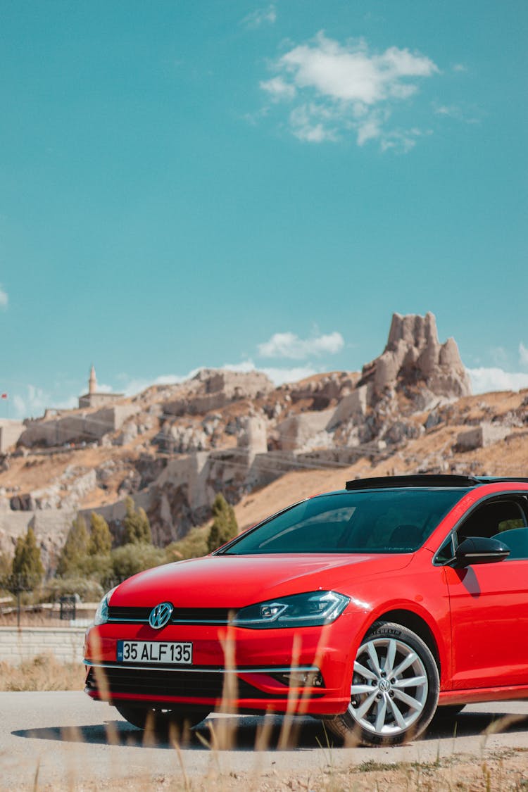 A Red Car Parked On The Road