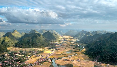 Free Stunning aerial shot of Bac Son Valley's lush landscape with mountains and a river. Stock Photo