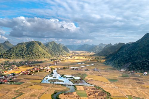 Free Stunning aerial shot of Bac Son Valley's lush landscape with mountains and river. Stock Photo