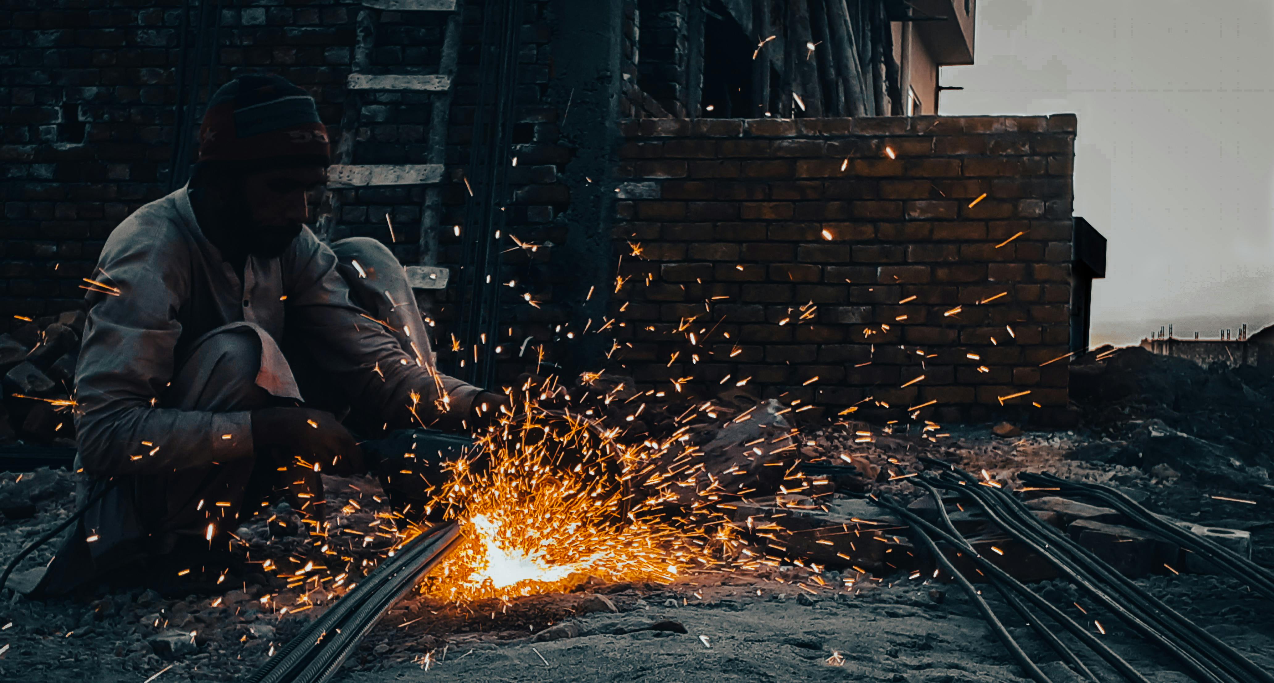 construction worker cutting metal