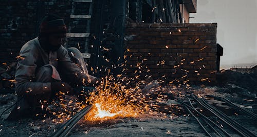 Construction Worker Cutting Metal 