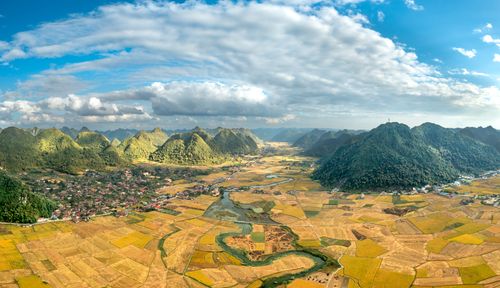Free A breathtaking aerial panorama of Bac Son Valley with lush mountains and golden fields. Stock Photo