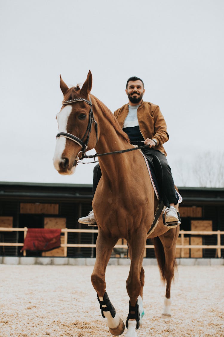 A Bearded Man Riding A Horse 