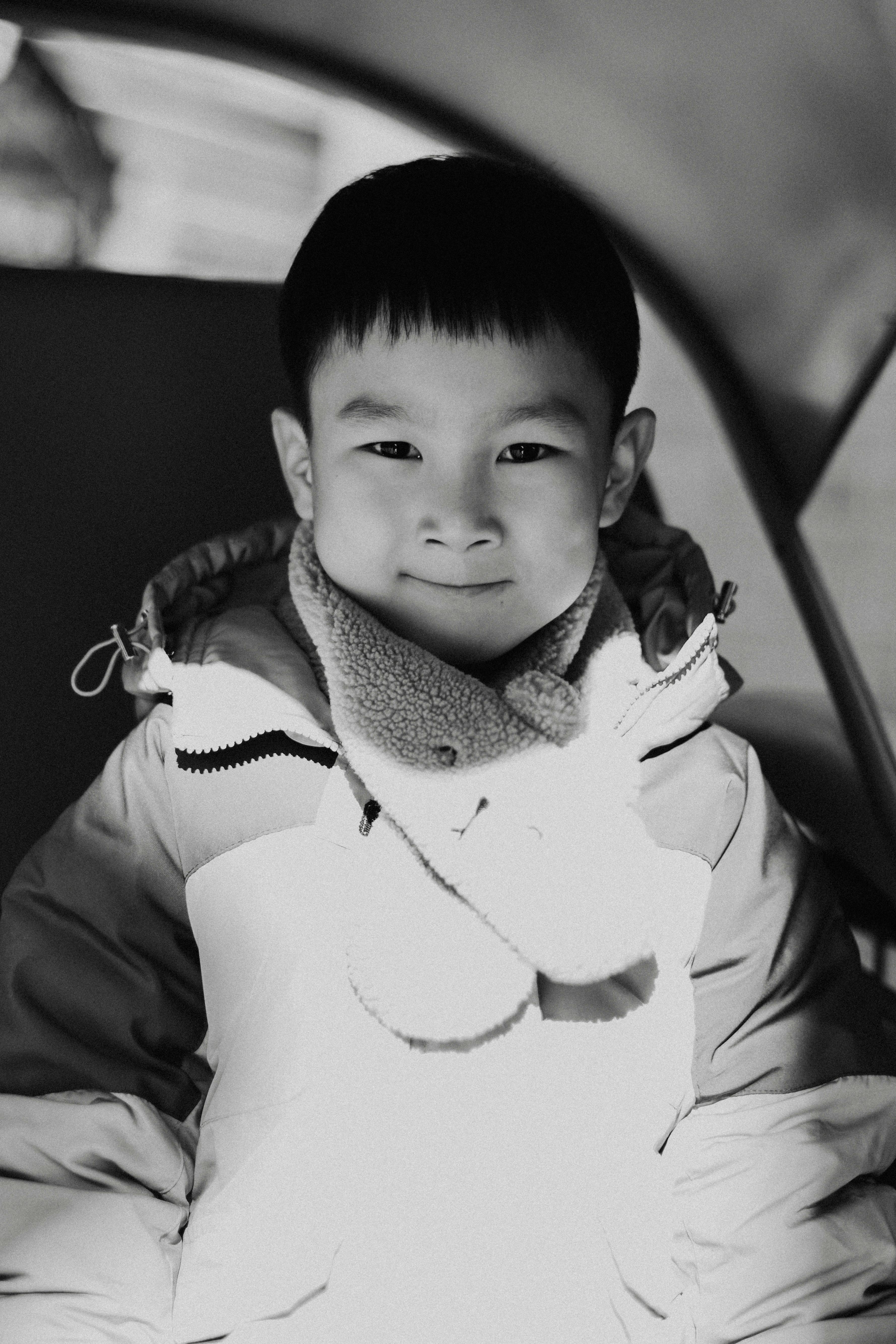 grayscale portrait of a boy in a jacket