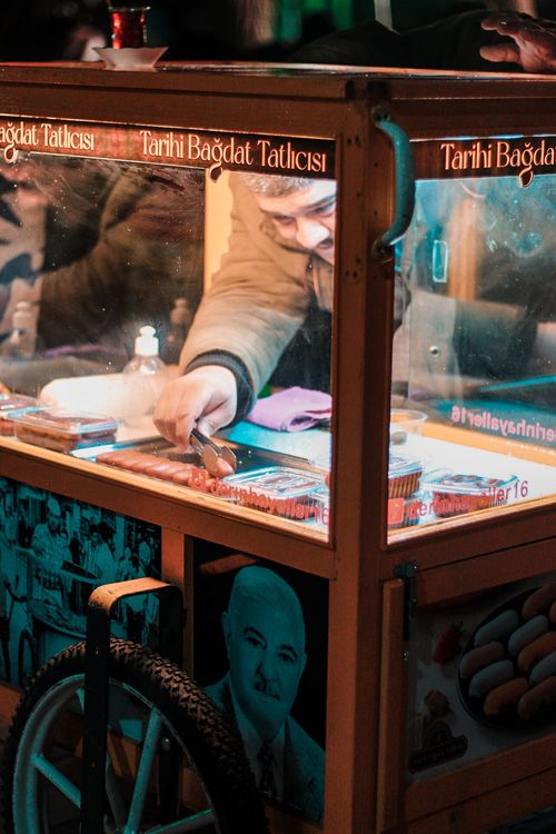 Free Man serving traditional sweets from a food cart on the streets of Bursa, Turkey. Stock Photo