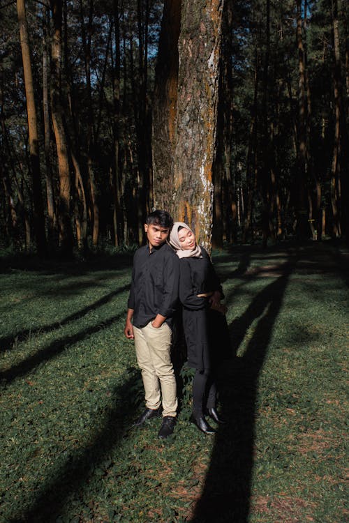 Free Couple in Front of a Tree in a Forest  Stock Photo