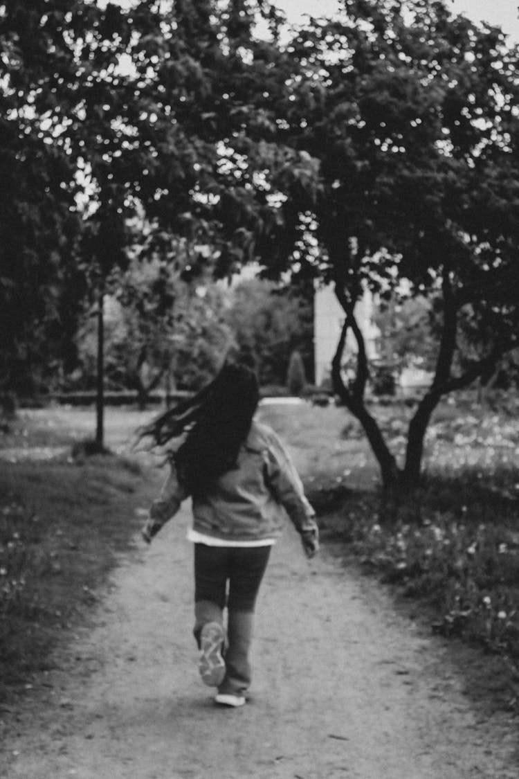 Monochrome Photo Of A Girl Running On A Path