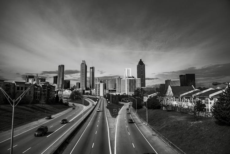 An Aerial Shot Of A Highway With The City In The Background