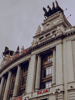 Grand facade of a historical building in Madrid with sculptures