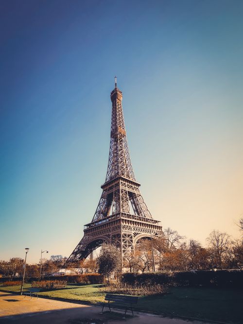 Free A stunning view of the Eiffel Tower in Paris, France under a clear blue sky. Stock Photo