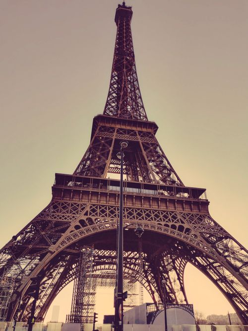 Free Spectacular low angle view of Eiffel Tower at dusk, set against a soft sky in Paris, France. Stock Photo