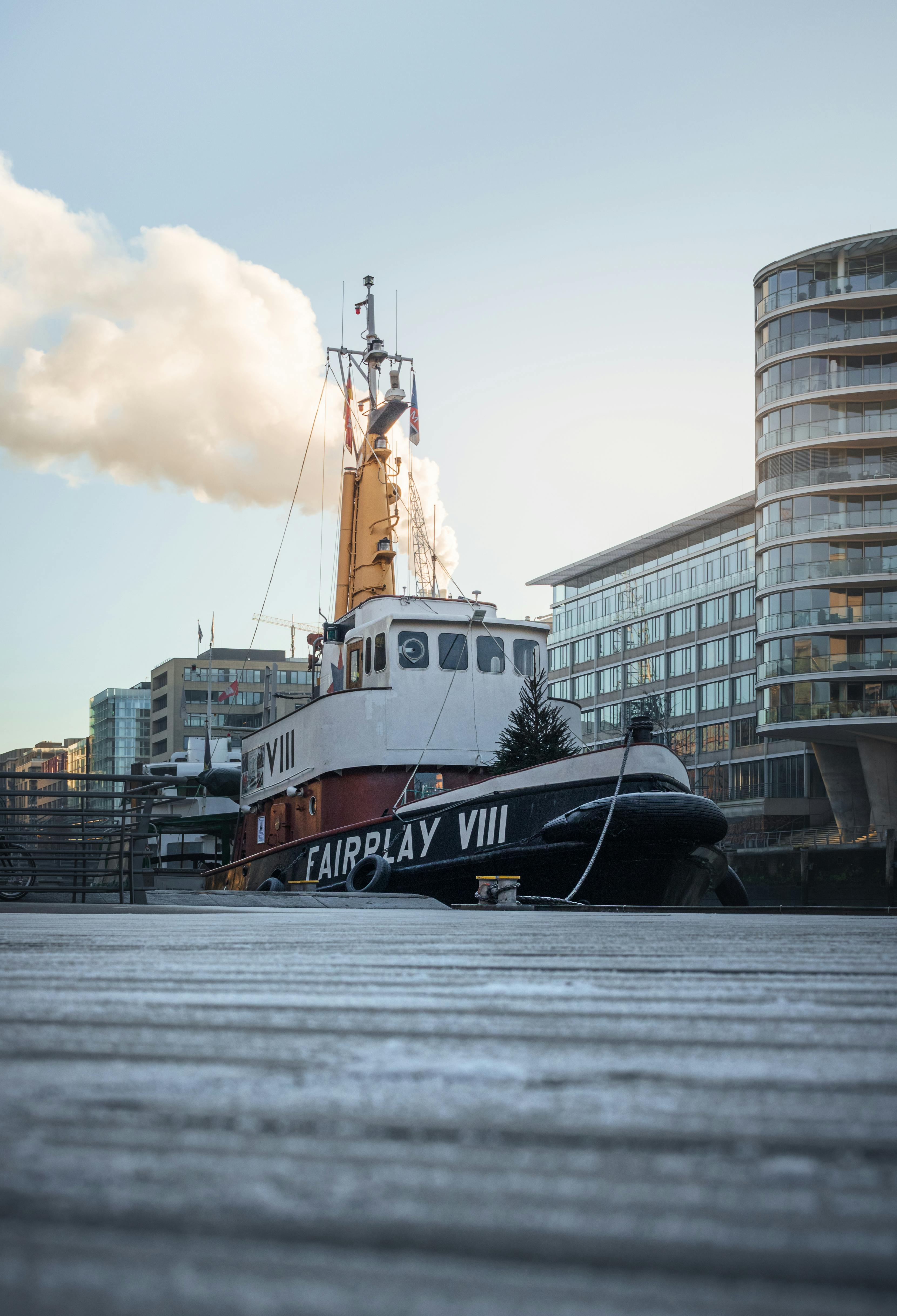 a tug boat is parked in front of a building