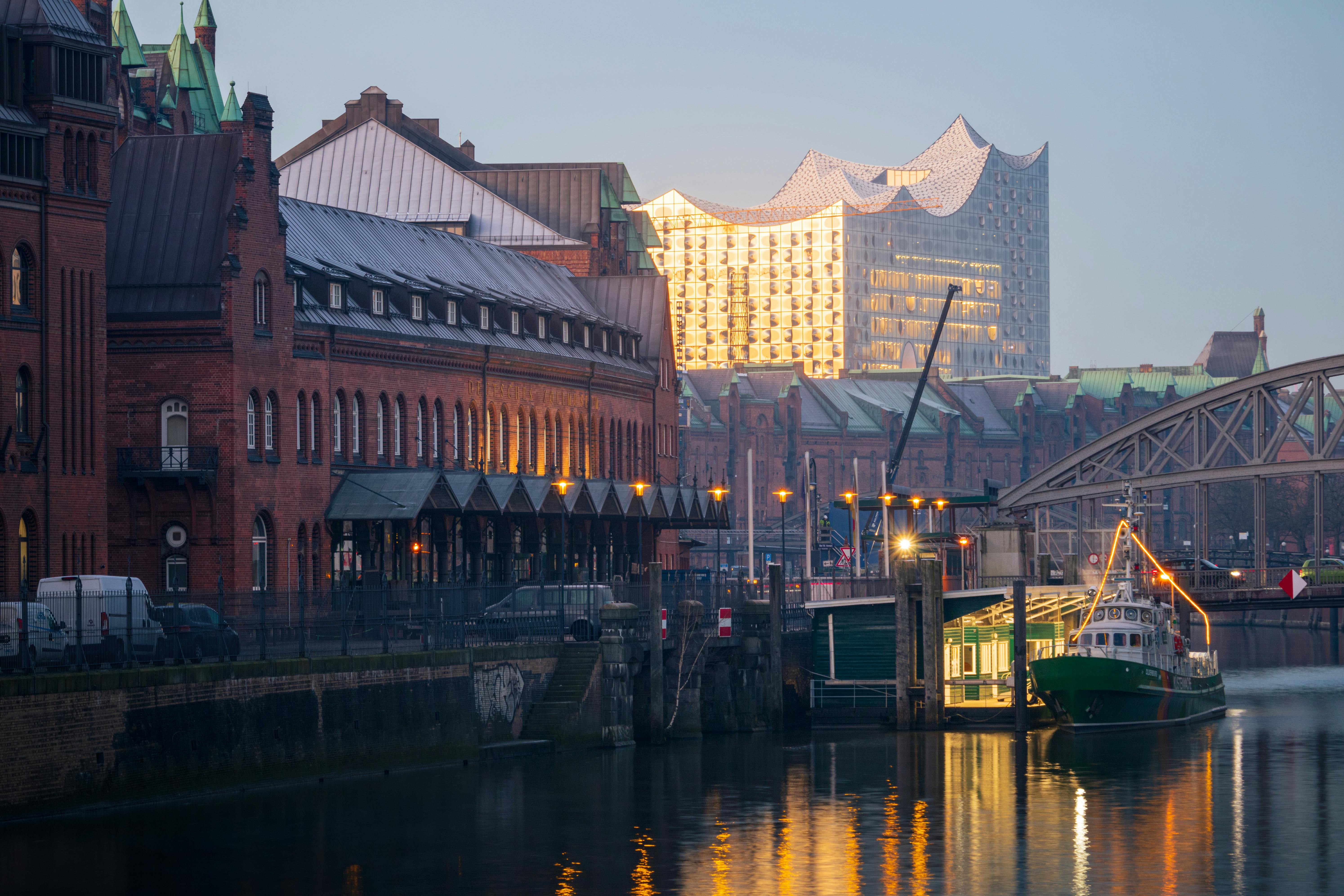 a boat is docked in a river near a building