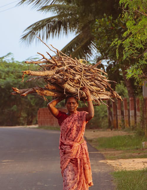 Woman Carrying Branches on Head