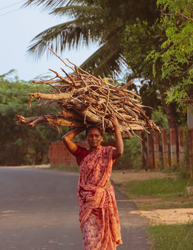 Woman Carrying Branches On Head