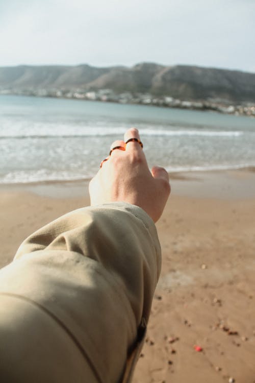 Woman Hand over Beach