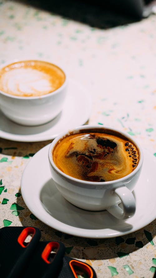 Black Coffee and Latte in White Cups on Table