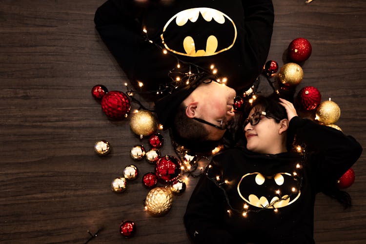 Couple Lying On The Floor Near Christmas Balls