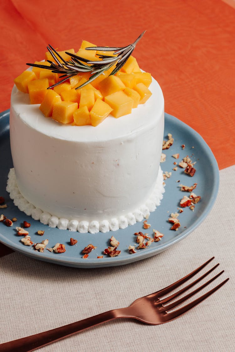 Cake With Chopped Fruits And A Twig On Top