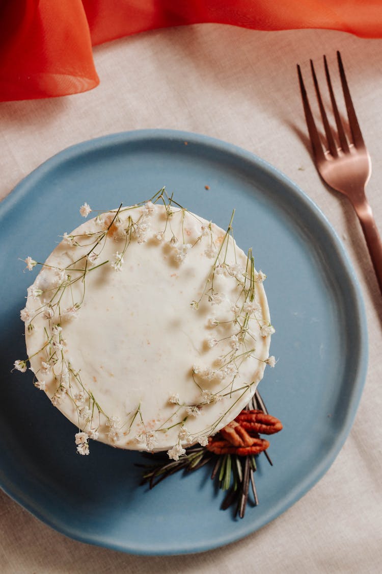 A Carrot Cake Served On A Plate With Fork