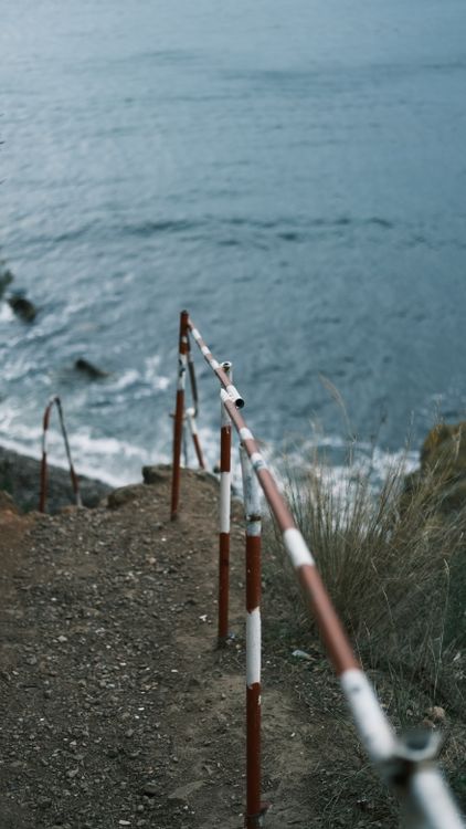 Ocean With Railing Railing on Sea Shore · Free Stock Photo