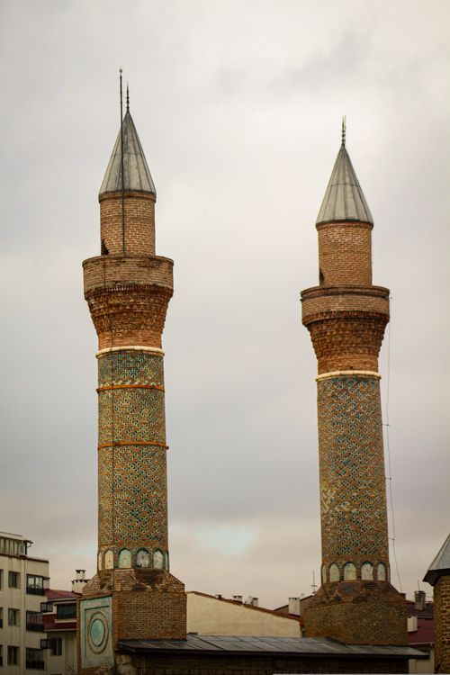 Free Elegant minarets rise beneath an overcast sky, showcasing Islamic architecture. Stock Photo