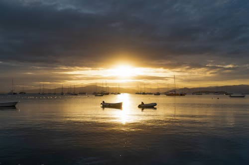 Silhouettes of Boats in a Harbor During Sunset 