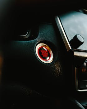 Close-up image of a car's engine start-stop button highlighting modern automotive technology.