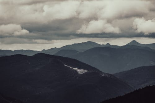 Photo of Mountains under Cloudy Sky