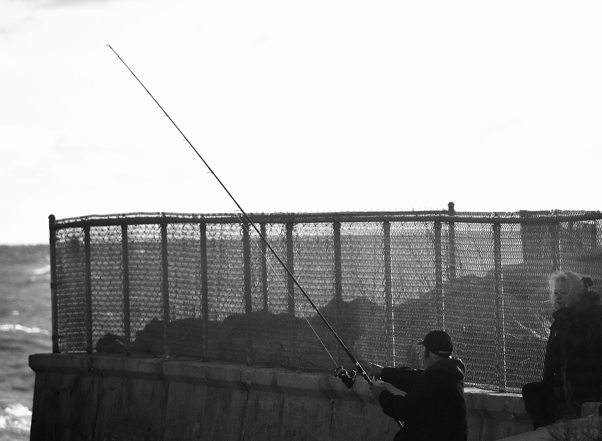 A tranquil fishing moment captured by the sea in Rhode Island.