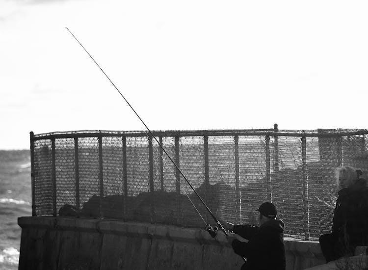 Mature Couple Fishing At The Coast