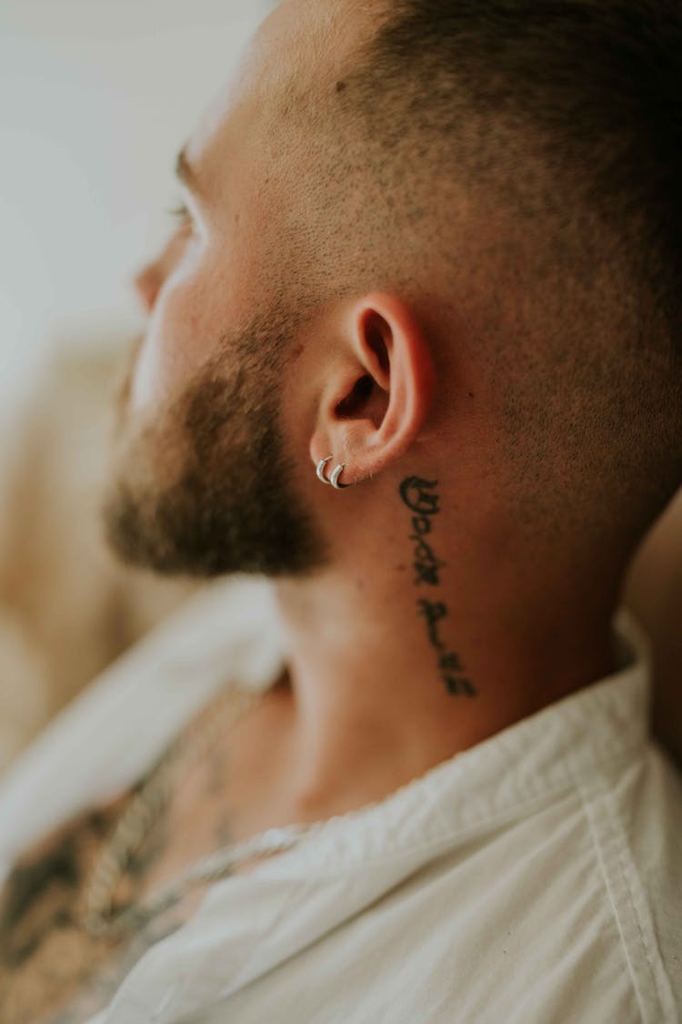 Man With Tattoos And Piercings