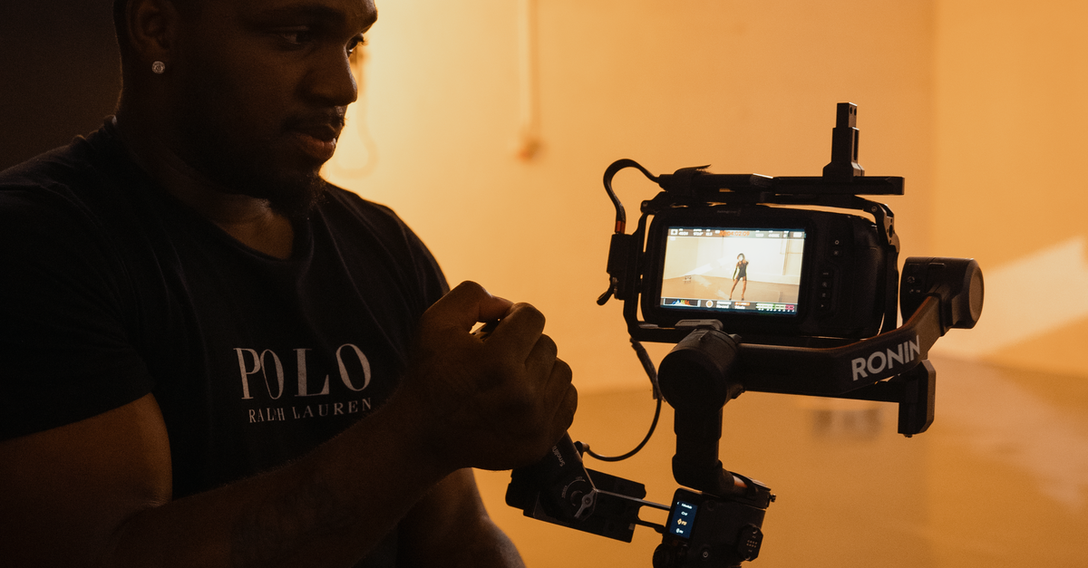 Operating A Camera Young Man Operating a Movie Camera · Free Stock Photo