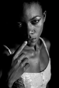 Intense black and white portrait of a woman with a contemplative pose.