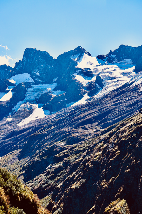 Free Majestic snow-capped mountain peaks under a clear blue sky, capturing the beauty of a scenic winter landscape. Stock Photo