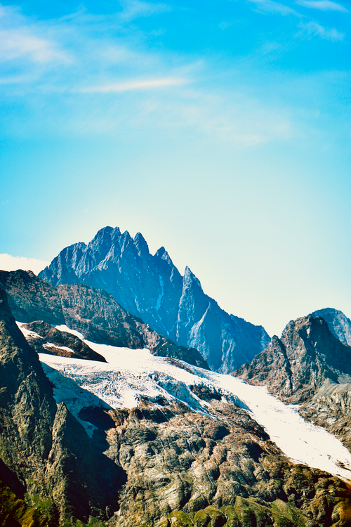 Free Scenic mountain landscape showcasing stunning snow-capped peaks under a clear blue sky. Stock Photo