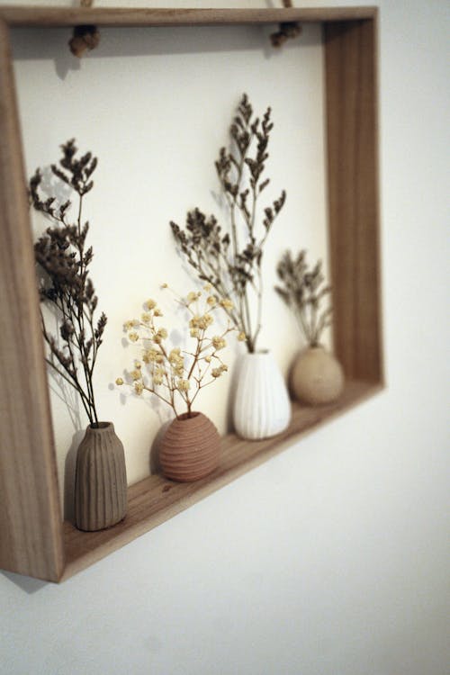 Twigs in Small Vases Standing on a Narrow Shelf
